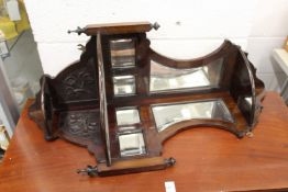 A mahogany mirror backed hanging corner wall shelf.