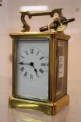 A brass carriage clock.