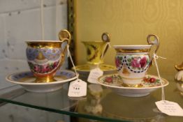 Three decorative Berlin cups and saucers.