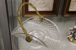 A cut glass basket with brass swing handle.