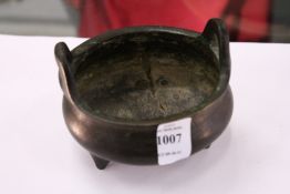 A Chinese bronze twin handled circular censer.