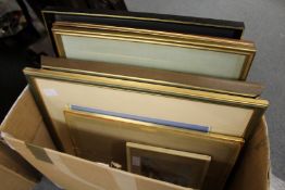 A box of paintings and prints.