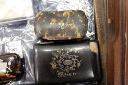 A tortoiseshell snuff box and a folding case.