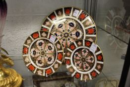 A Derby Imari circular stand and two small similar plates.