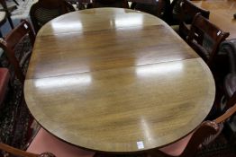 A mahogany single pedestal extending dining table.