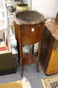 An Edwardian mahogany jardiniere stand with copper liner.