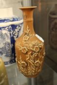 A Chinese bottle vase with moulded prunus decoration.