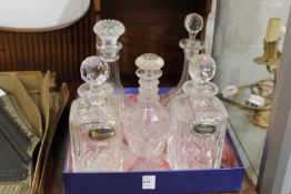 A pair of cut glass whisky decanters and three others.