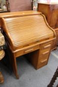 An oak roll top desk.