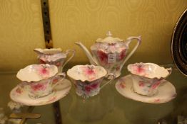 A porcelain floral decorated part tea service.