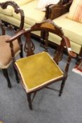 A mahogany corner armchair.
