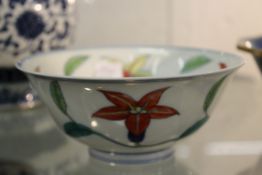 A Chinese porcelain small circular bowl decorated with entwined flowers.