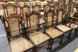 An impressive set of twelve early 20th century Indian teak dining chairs, two with arms all with