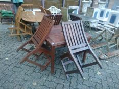 A small square garden table and four chairs.