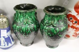 A pair of green glazed pottery vases.