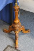 A good carved walnut and brass tripod lamp standard.