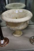 A carved alabaster urn.
