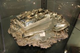 A silver serving spoon, a plated salver and other collectable spoons.