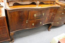 A mahogany serpentine fronted sideboard.