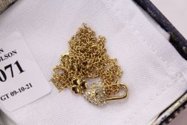 A decorative heart shaped padlock pendant and chain.