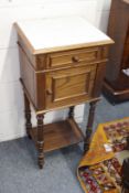 A French oak and marble top bedside cupboard.