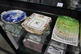 A blue and white dish, decorative serving dishes and a pair of asparagus dishes.
