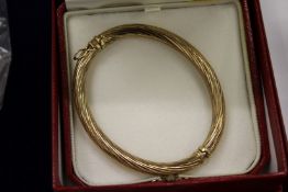 An Annabel Jones 9ct gold bangle, with original box.