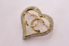 A decorative heart shaped brooch.