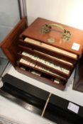 A mahogany cased Mahjong set with hardwood stands.