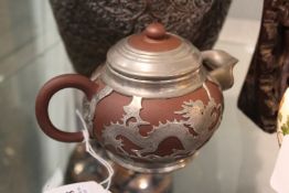 A Chinese pewter mounted Yixing teapot.