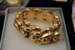 A hollow curb link bracelet stamped 750.