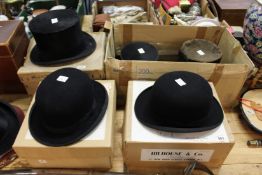 Two bowler hats and three top hats, some with boxes.