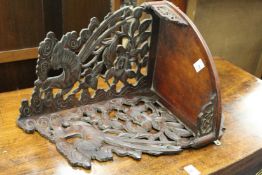 A carved wood hanging corner wall shelf.