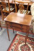 A good early 19th century mahogany two drawer side table with ebony inlaid decoration on turned