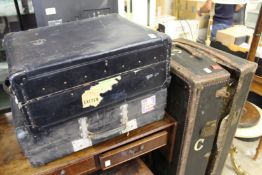 A wardrobe trunk and two other cases.