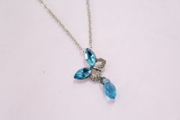 A decorative pendant and chain, boxed.