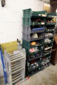 A folding ladder Workmate and a quantity of storage shelves containing numerous tools.