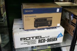 A Denon CD receiver and a Rotel CD player boxed.