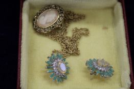 A pair of decorative earrings and a pendant and chain.