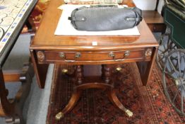 A mahogany drop leaf single pedestal table.