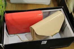 A LK Bennett patent leather clutch bag and a Hobbs coral coloured clutch bag.