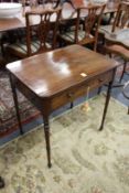 A good George III mahogany occasional table with single frieze drawer, candle slides to each end