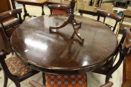 A mahogany circular breakfast table.