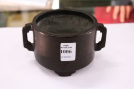 A Chinese bronze twin handled circular censer.