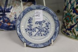 A small 18th century Kangxi Batavian saucer with blue and white decoration.