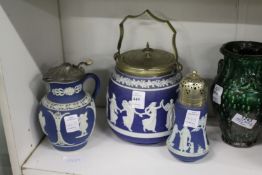A Jasper ware biscuit barrel, jug and sugar sifter.