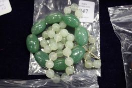 A jade bracelet and a necklace.