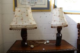 A pair of decorative table lamps, the bases carved as African busts.