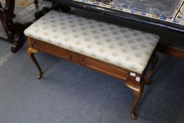 A mahogany duet music seat.