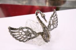 A silver mounted cut glass table salt in the form of a swan with hinged wings.